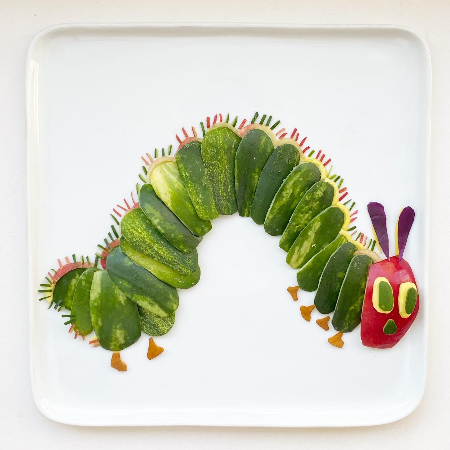 In memory of Eric Carle – watermelon, apple, purple cabbage, squash, pickle, pear and peach by Harley Langberg