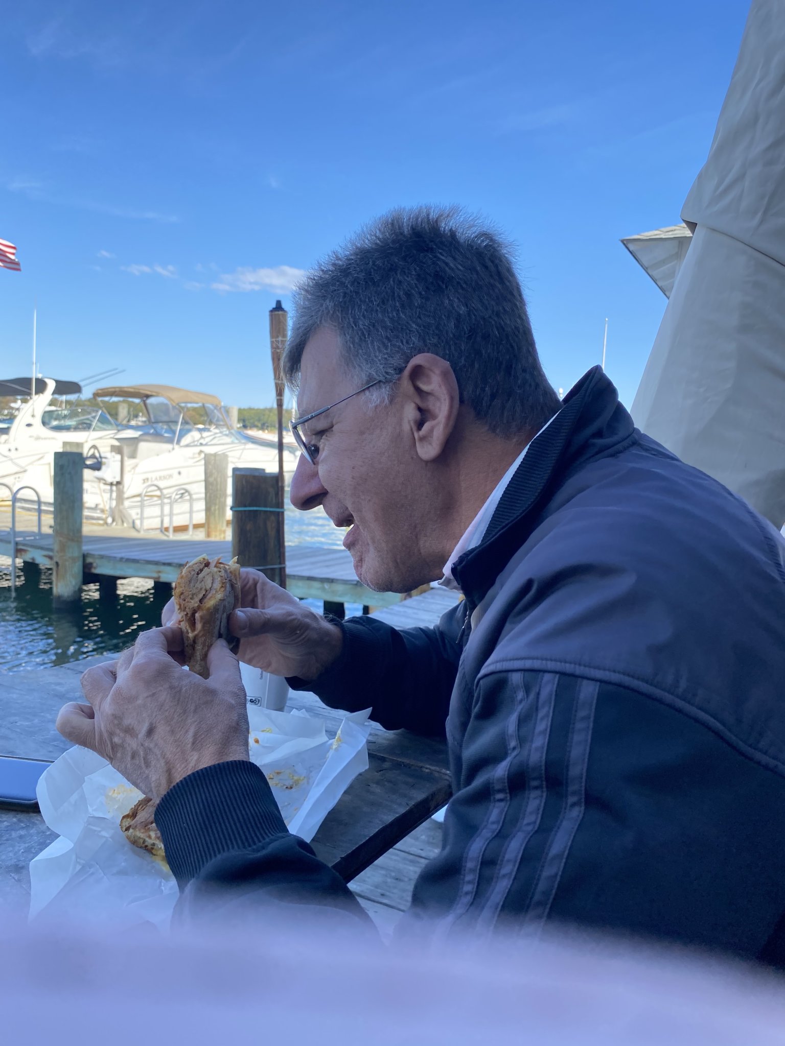 Roman takes a bite of “The Cuban” sandwich, which is now a favorite of mine, too!