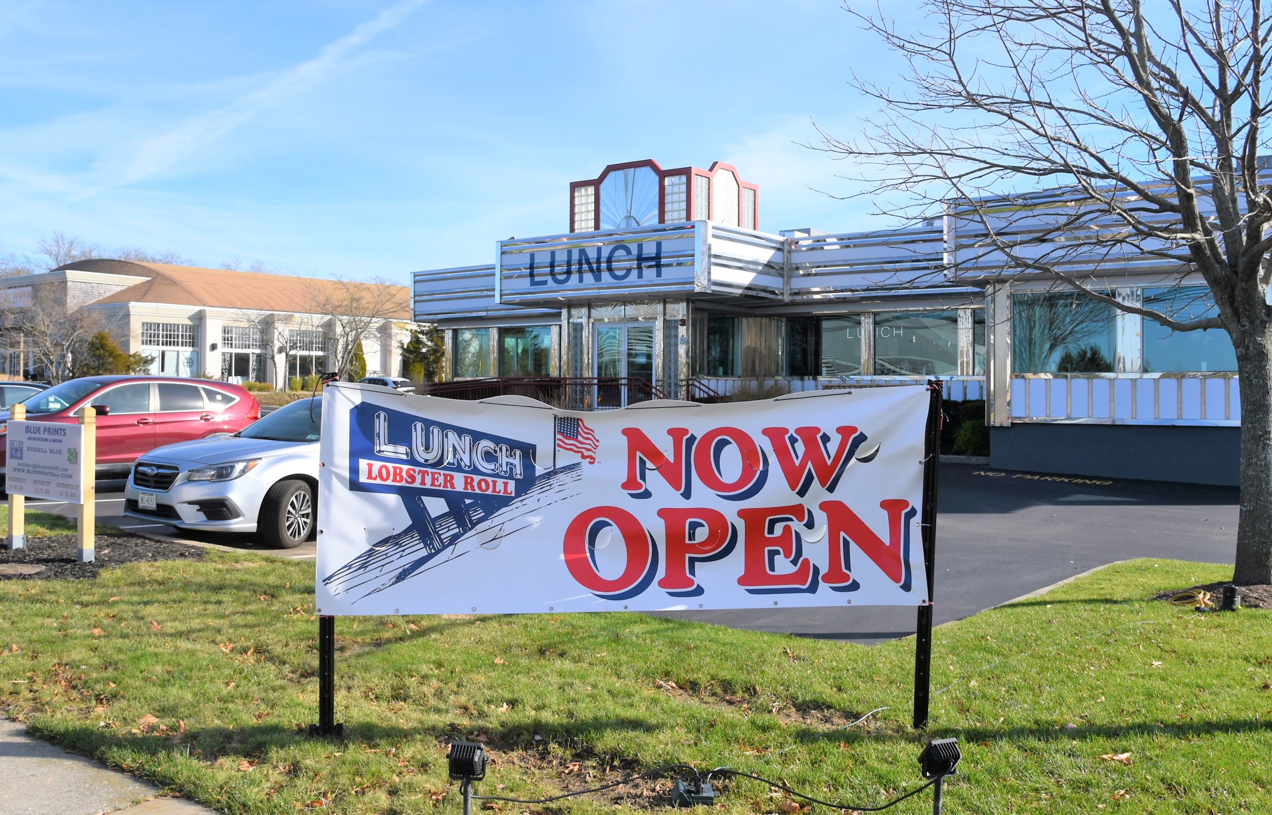 The LUNCH sign once again welcomes motorists to dine at the Lobster Roll for lunch (or a family dinner)