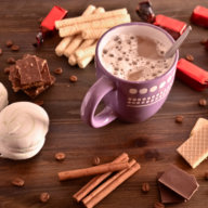 coffee mood, coffee beside chocolate waffles coffee grains and cinnamon sticks, coziness, selective focus.