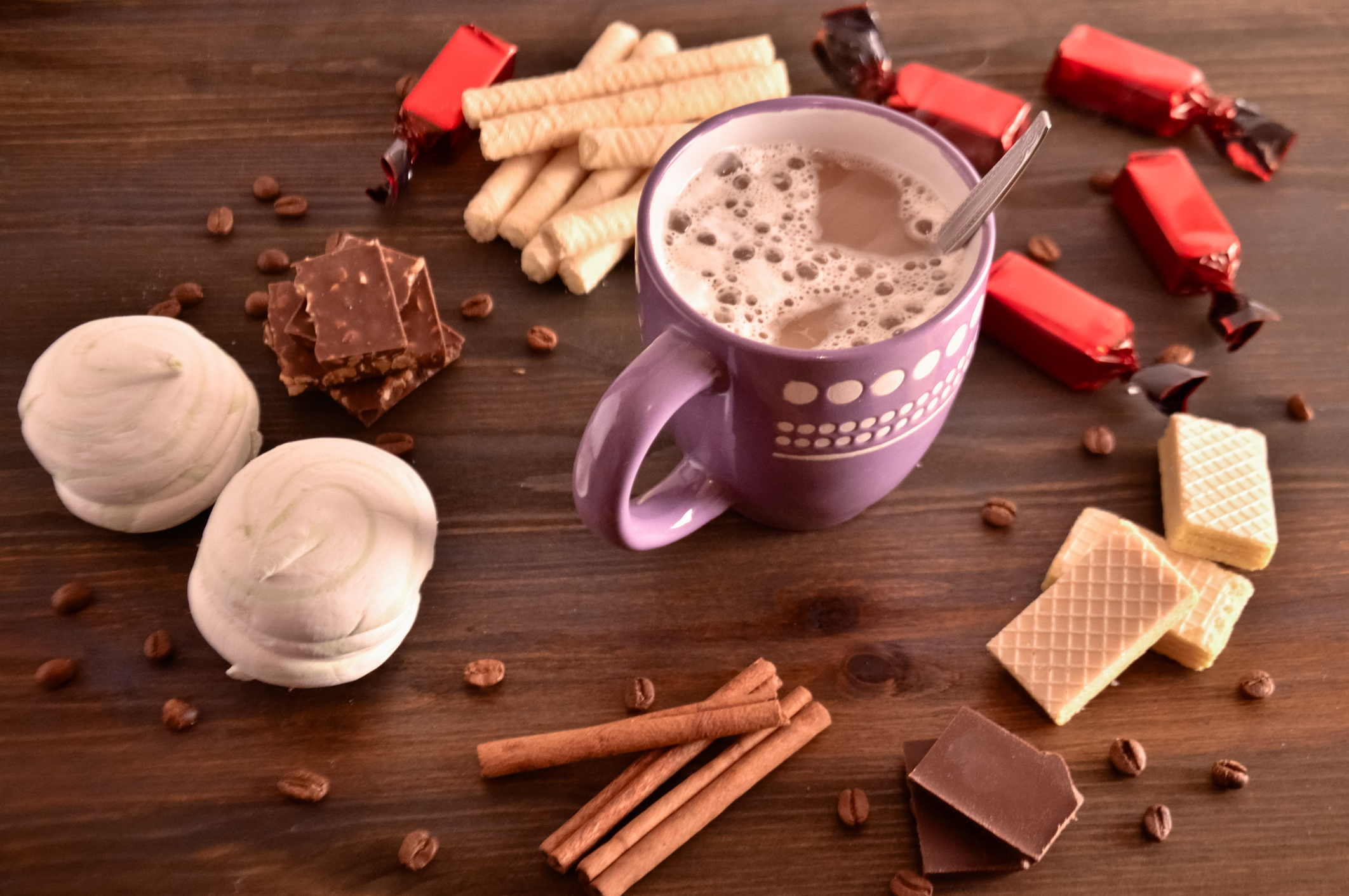 coffee mood, coffee beside chocolate waffles coffee grains and cinnamon sticks, coziness, selective focus.