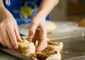 Kid Baking Cinnamon Rolls Homemade; focus on hands.