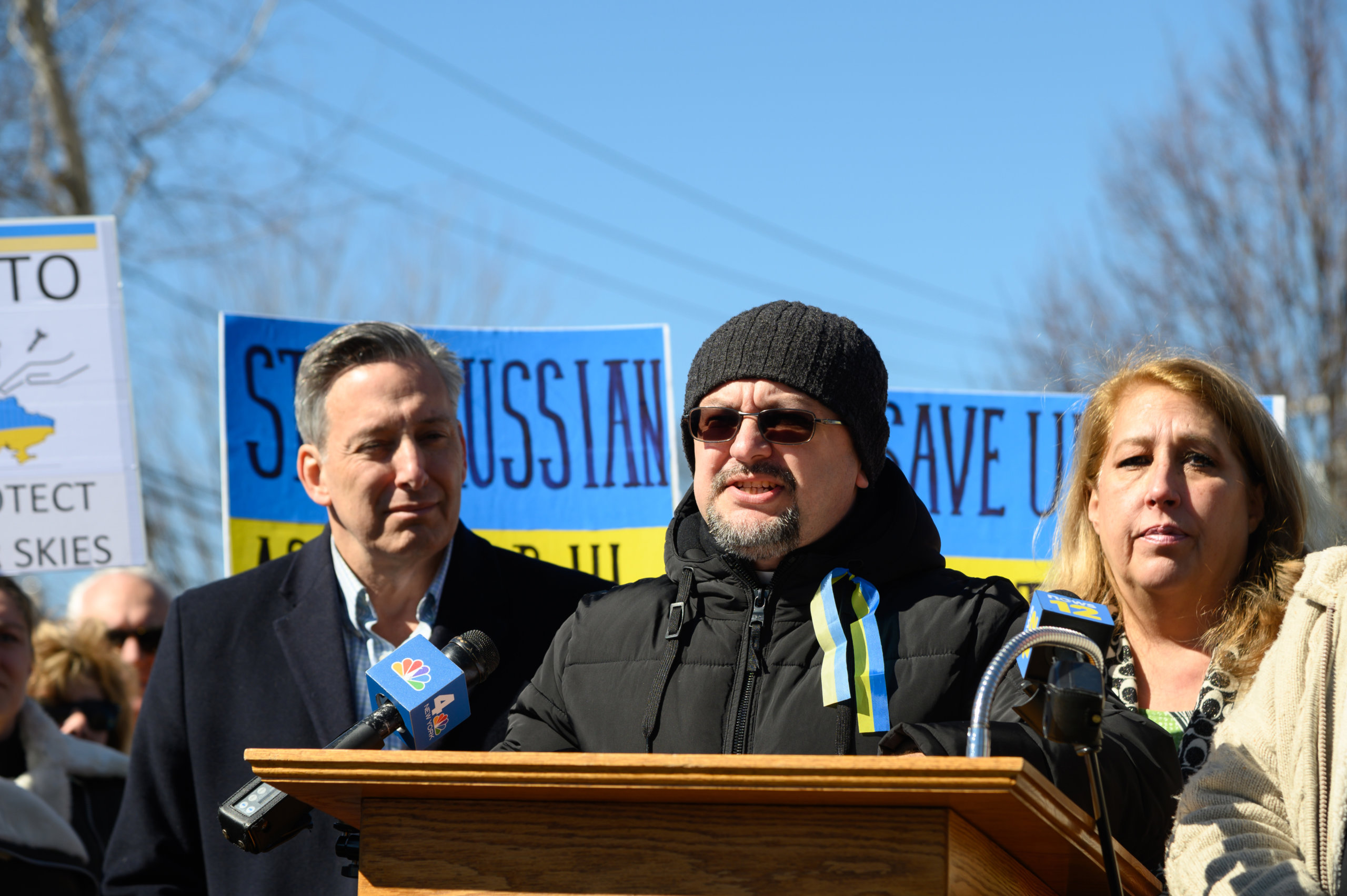 Bohdan Hedz, parish priest of St. John The Baptist Ukrainian Catholic Church, speaks at a rally on February 28, 2022 alongside Suffolk County Deputy County Executive Jon Kaiman and Riverhead Town Supervisor Yvette Aguiar.