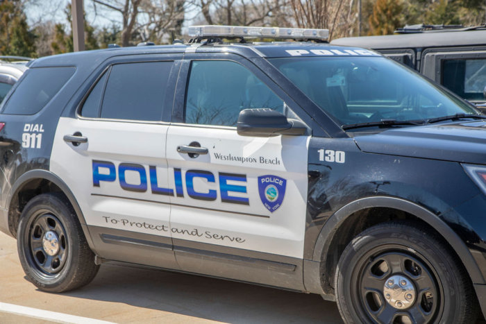 A Westhampton Beach police car emblazoned with the department’s oath “To protect and serve”