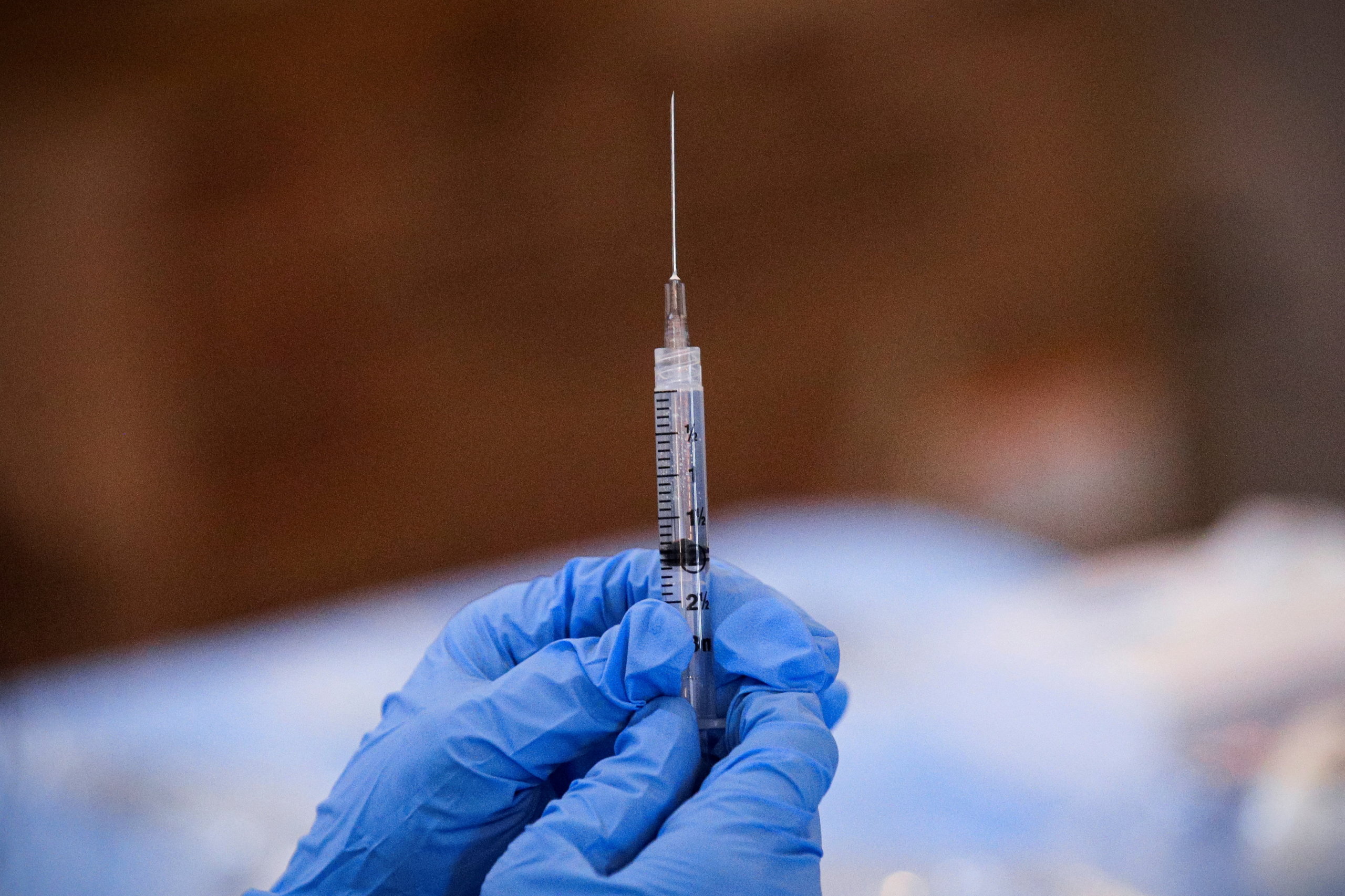 FILE PHOTO: A syringe is filled with a dose of Pfizer's coronavirus disease (COVID-19) vaccine at a pop-up community vaccination center on Long Island on February 23, 2021.