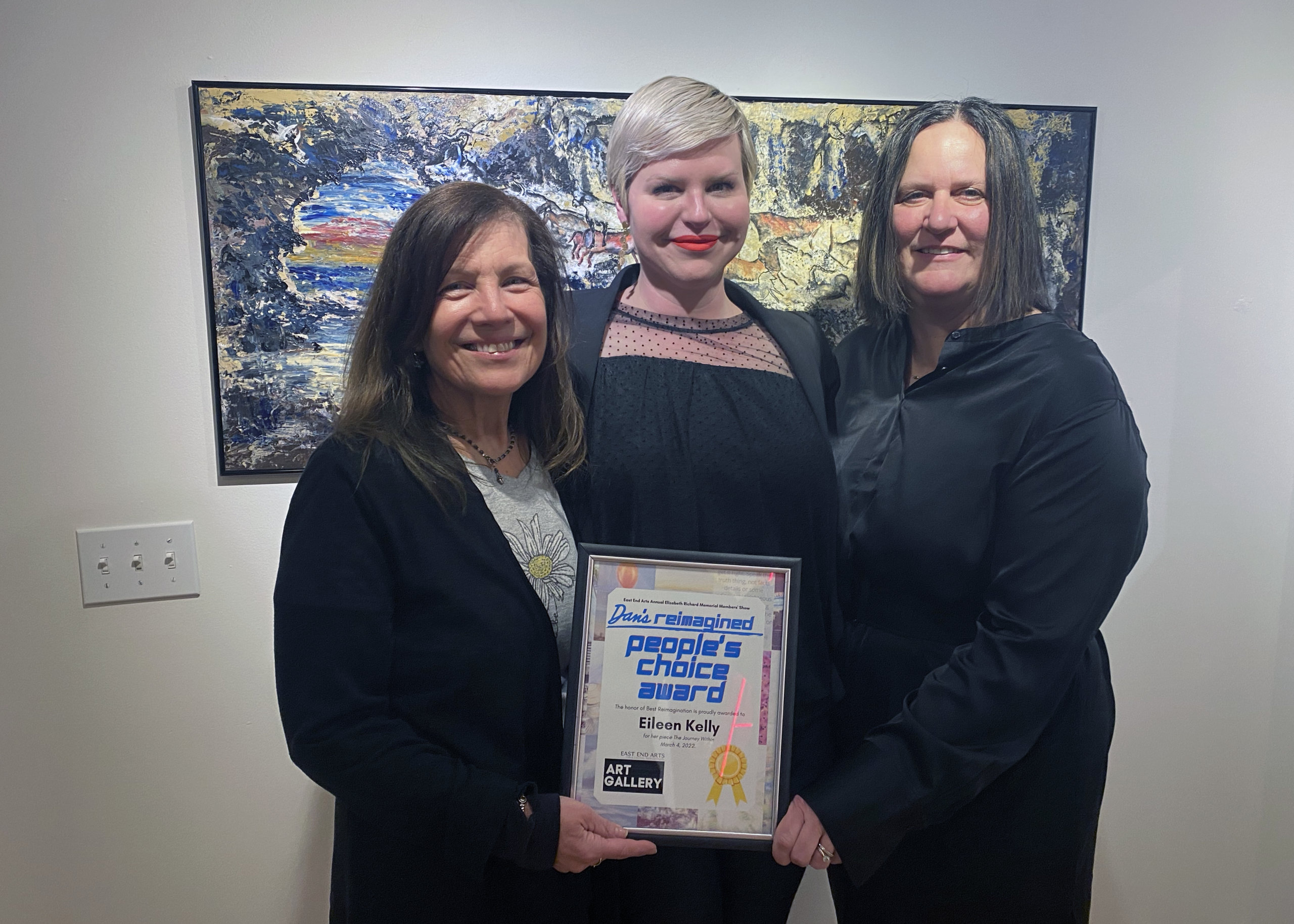 Eileen Kelly receives her "Dan's Reimagined" People's Choice awards from East End Arts Membership + Gallery Manager Wendy Weiss and EEA director Diane Burke