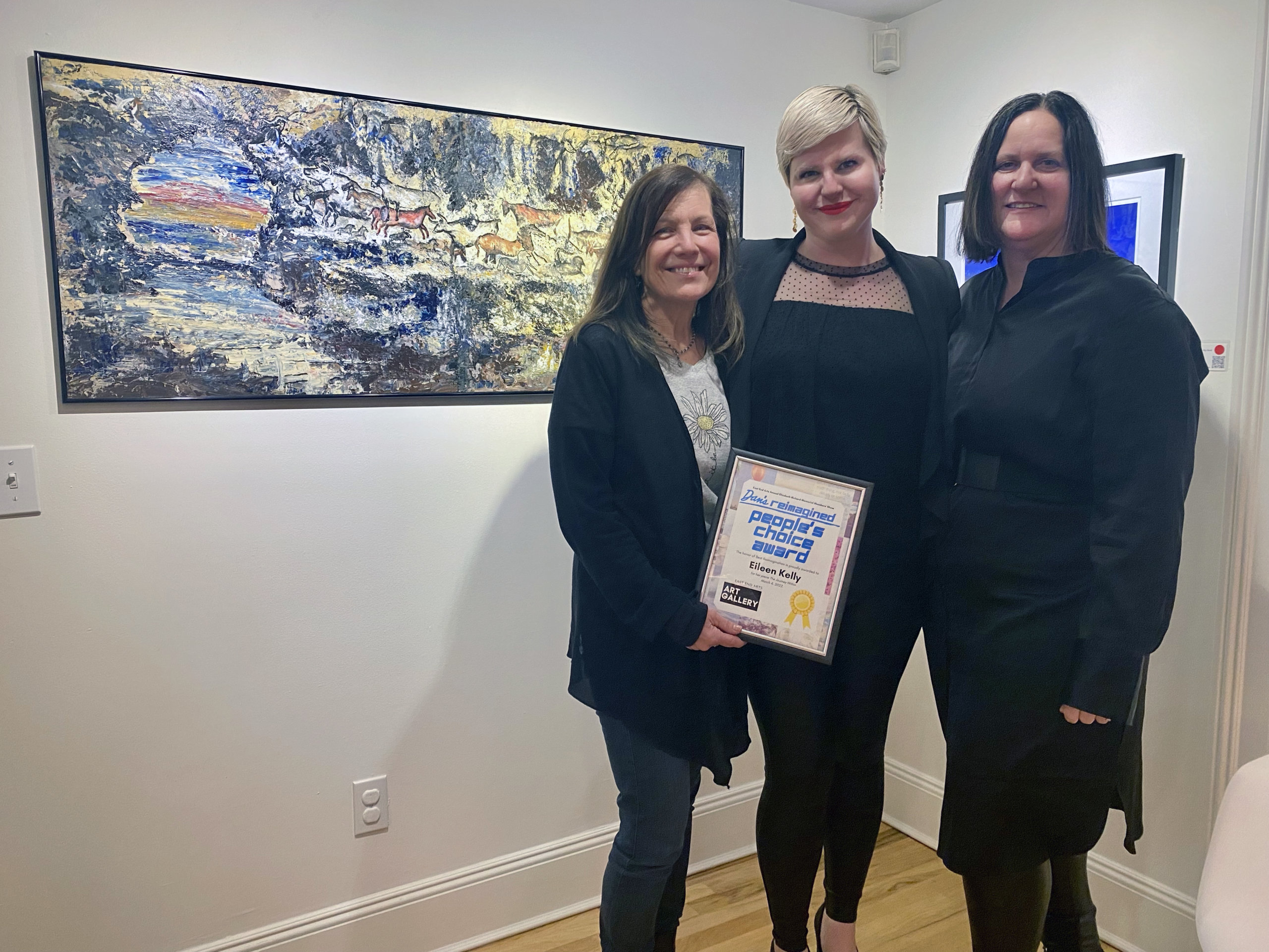 Eileen Kelly receives her "Dan's Reimagined" People's Choice awards from East End Arts Membership + Gallery Manager Wendy Weiss and EEA director Diane Burke