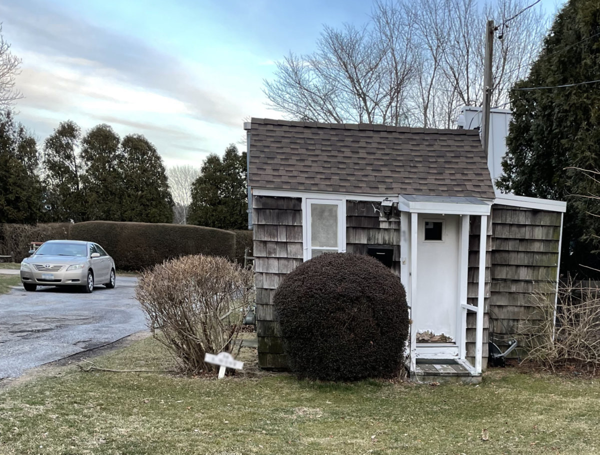 Car parking next to tiny house in the Hamptons