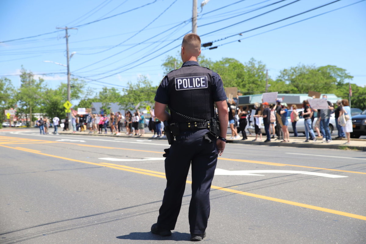 A Riverhead police officer watching the June 13, 2020, Black Lives Matter protest, which, like the governor’s call for police reform, was a direct response to the May 25 killing of George Floyd by a Minneapolis police officer