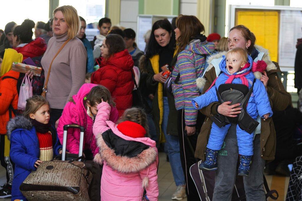 Ukrainian family at a train station in Przemysl, southeastern Poland after being driven from their home, Monday, March 28, 2022