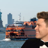 An image of a Staten Island ferry at downtown New York City with Statue of Liberty with Colin Jost