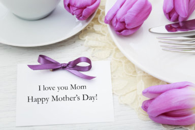 Mother's day card with table setting with purple tulips