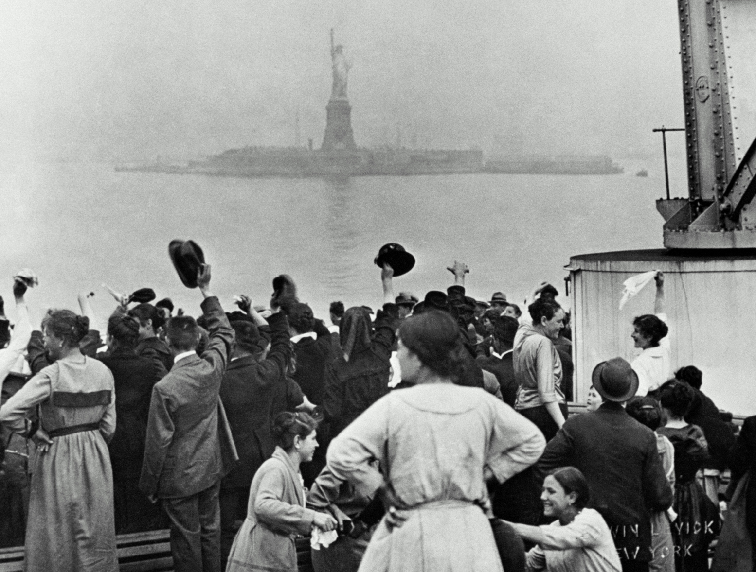 View from ship pulling into Ellis Island, c. 1900