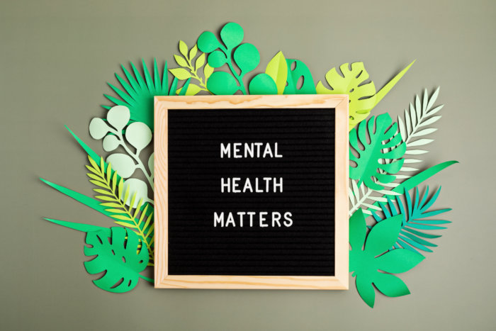 Mental health matters motivational quote on the letter board. Inspiration psycological text with paper cut leaves. Flat lay, top view