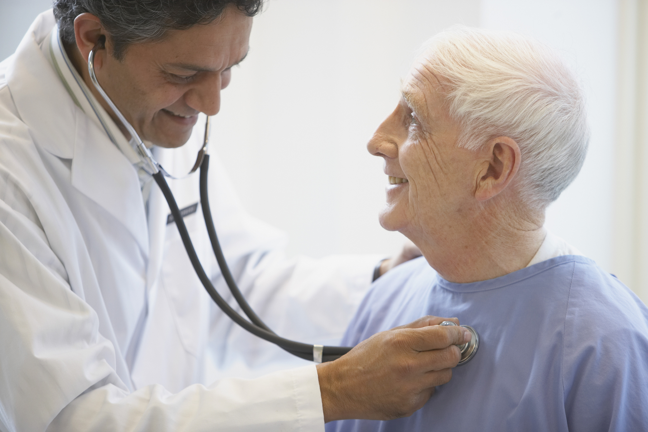 Doctor examining patient with stethoscope