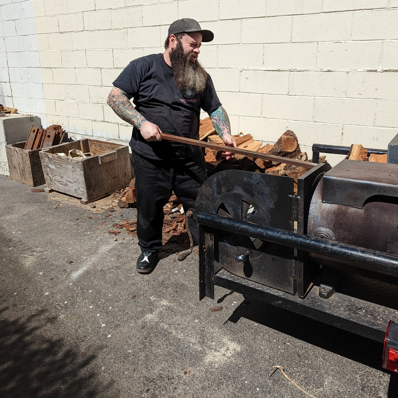 Larry Mondello at his homemade Meats Meat smoker