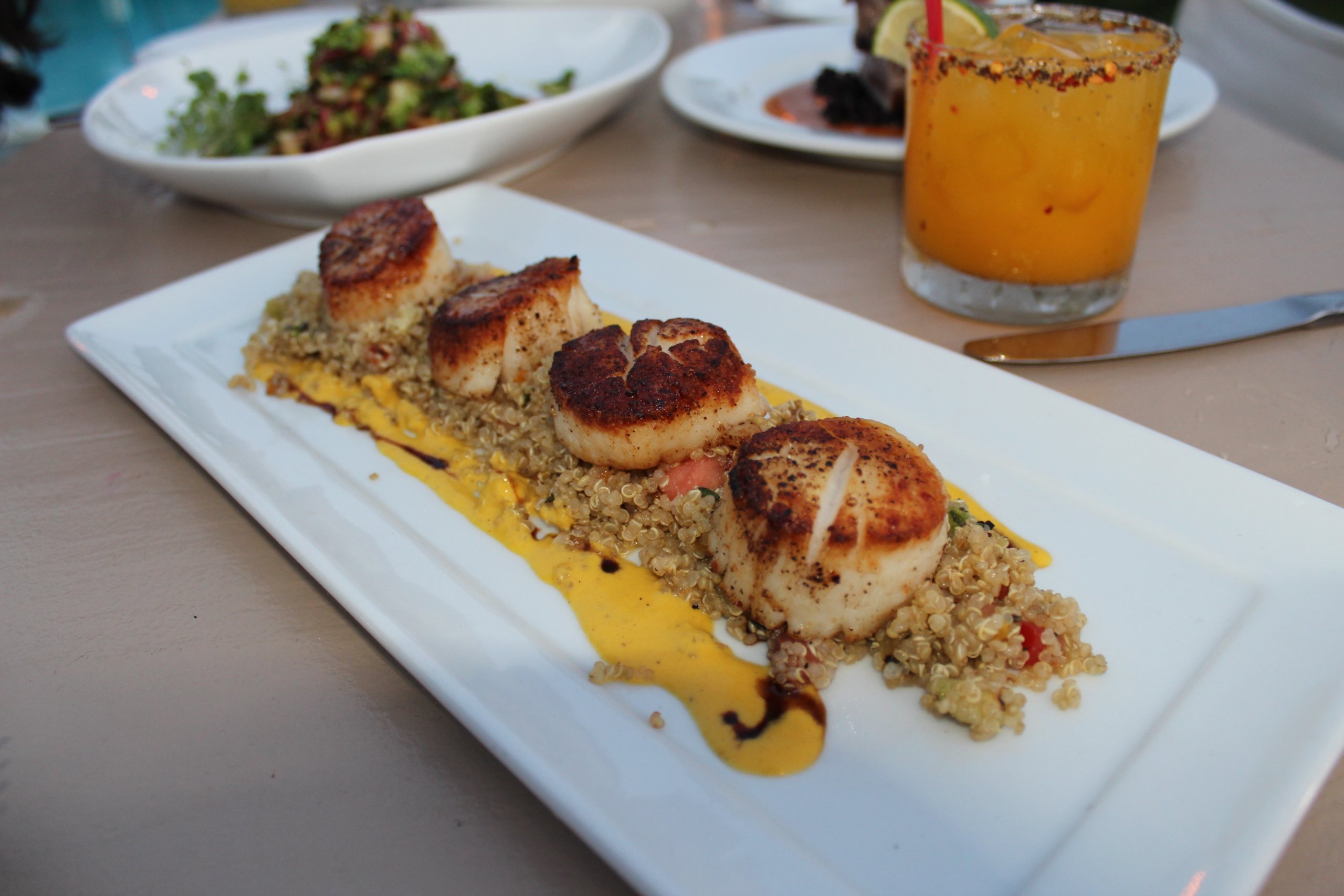 The seared scallops at the Backyard Restaurant at Solé East Resort