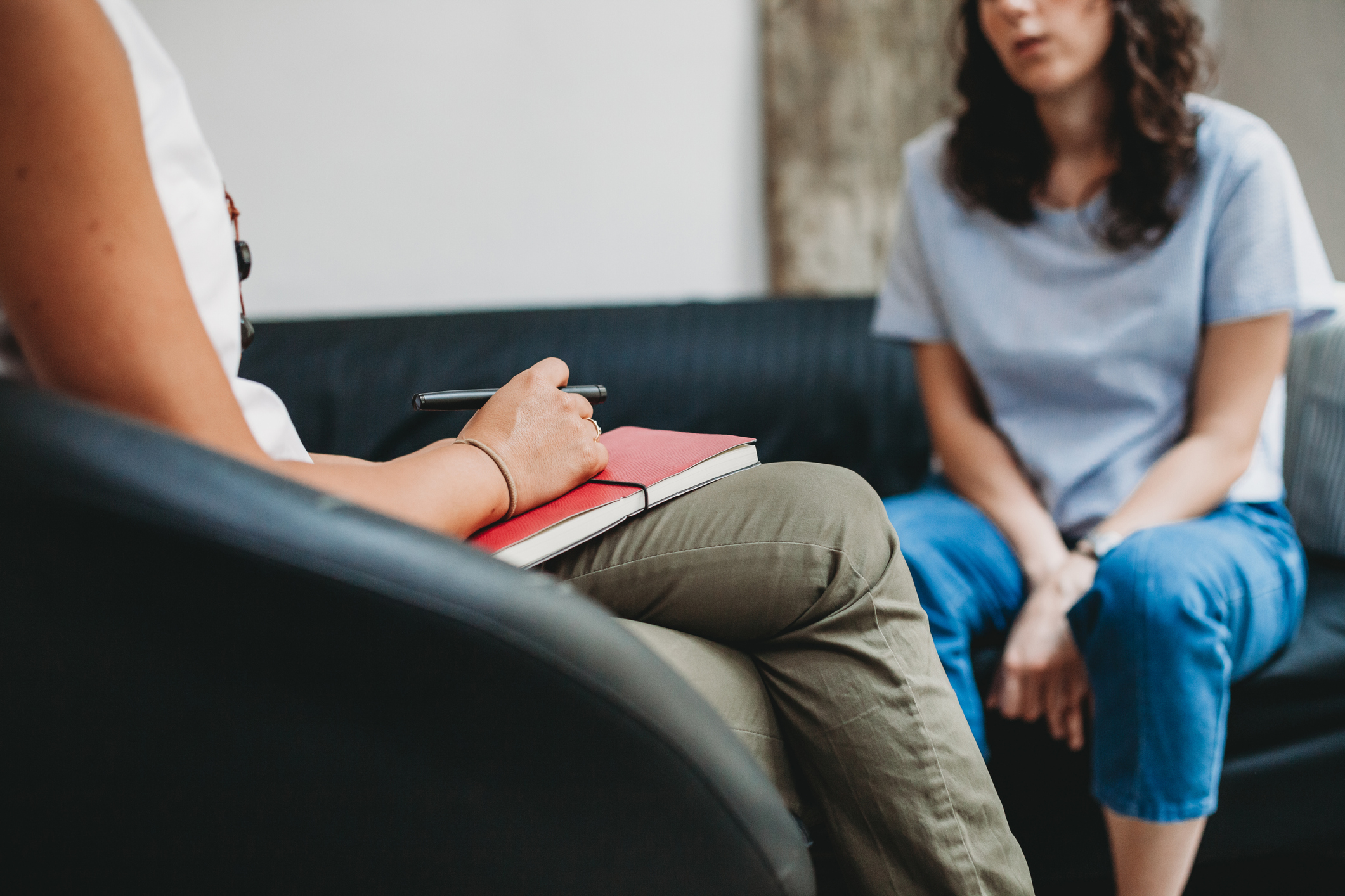 Psychotherapy session, woman talking to his psychologist in the studio - do you choose medication or hospitalization?