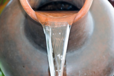 Close up Pour water out of terracotta pots. Understand kenosis