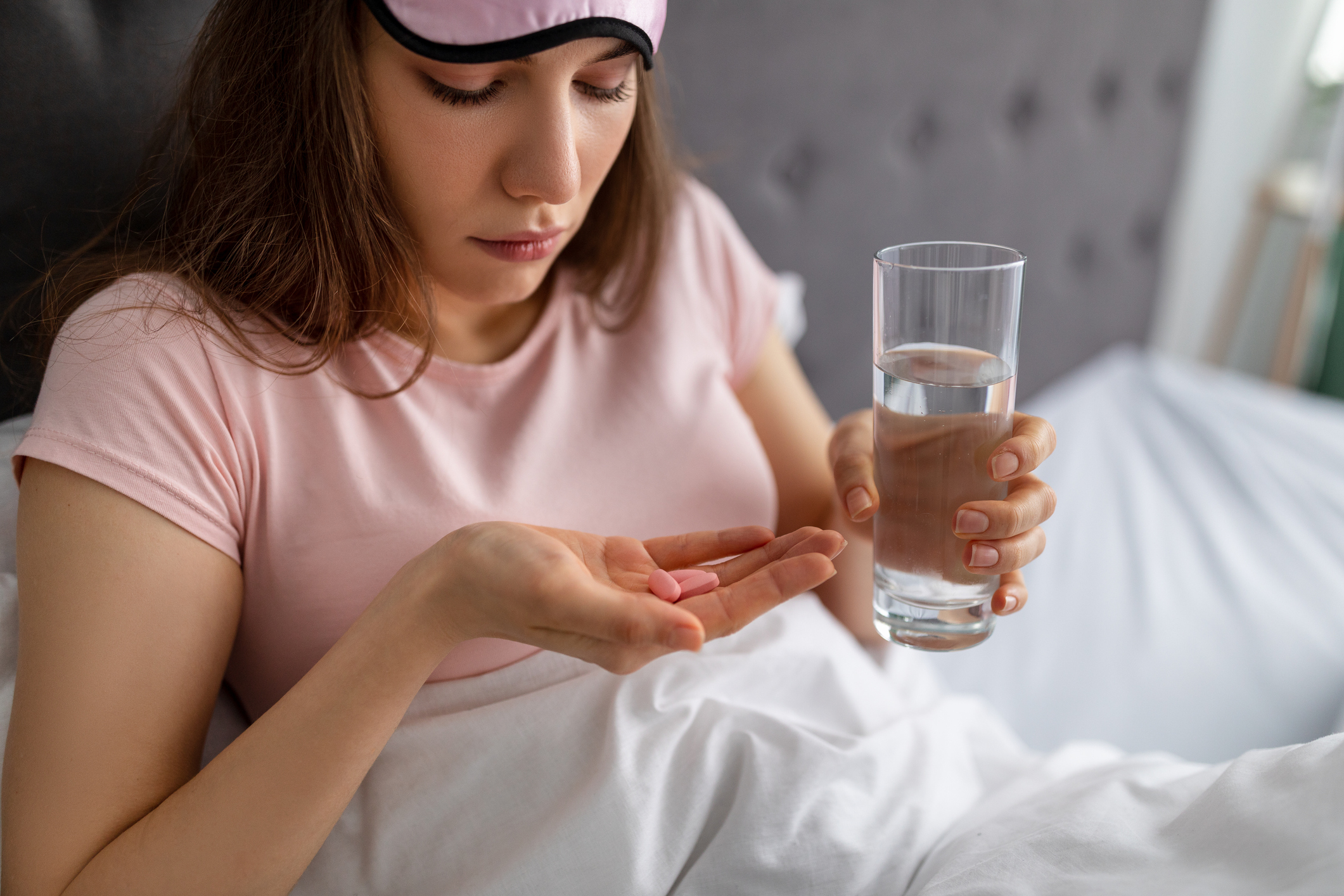 Young woman taking sleep aids