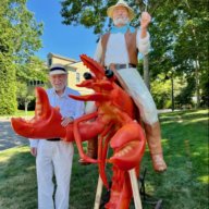 Dan Rattiner with his lobster statue outside of the new Dan's Papers office.