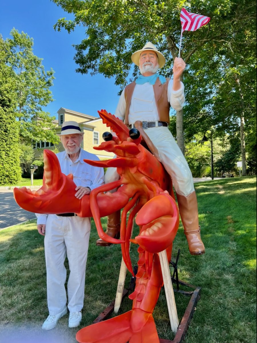 Dan Rattiner with his lobster statue outside of the new Dan's Papers office.