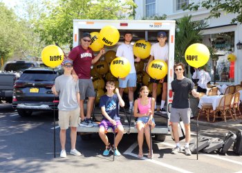 Coach Eddie Arnold, Jacob Warden, Jake Cook, Evan Simioni, Dylan Koszalka, Amanda Koszalka, Andrew Souhradh helped shops set up balloons for the Week of Hope and Race of Hope