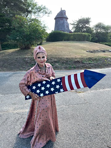 Tovah Feldshuh (as Beatrice) with a prop firework filming "Dirty Rhetoric"