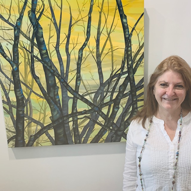 Donna Corvi with one of her paintings at Depot Gallery's recent Montauk Artists Association exhibition