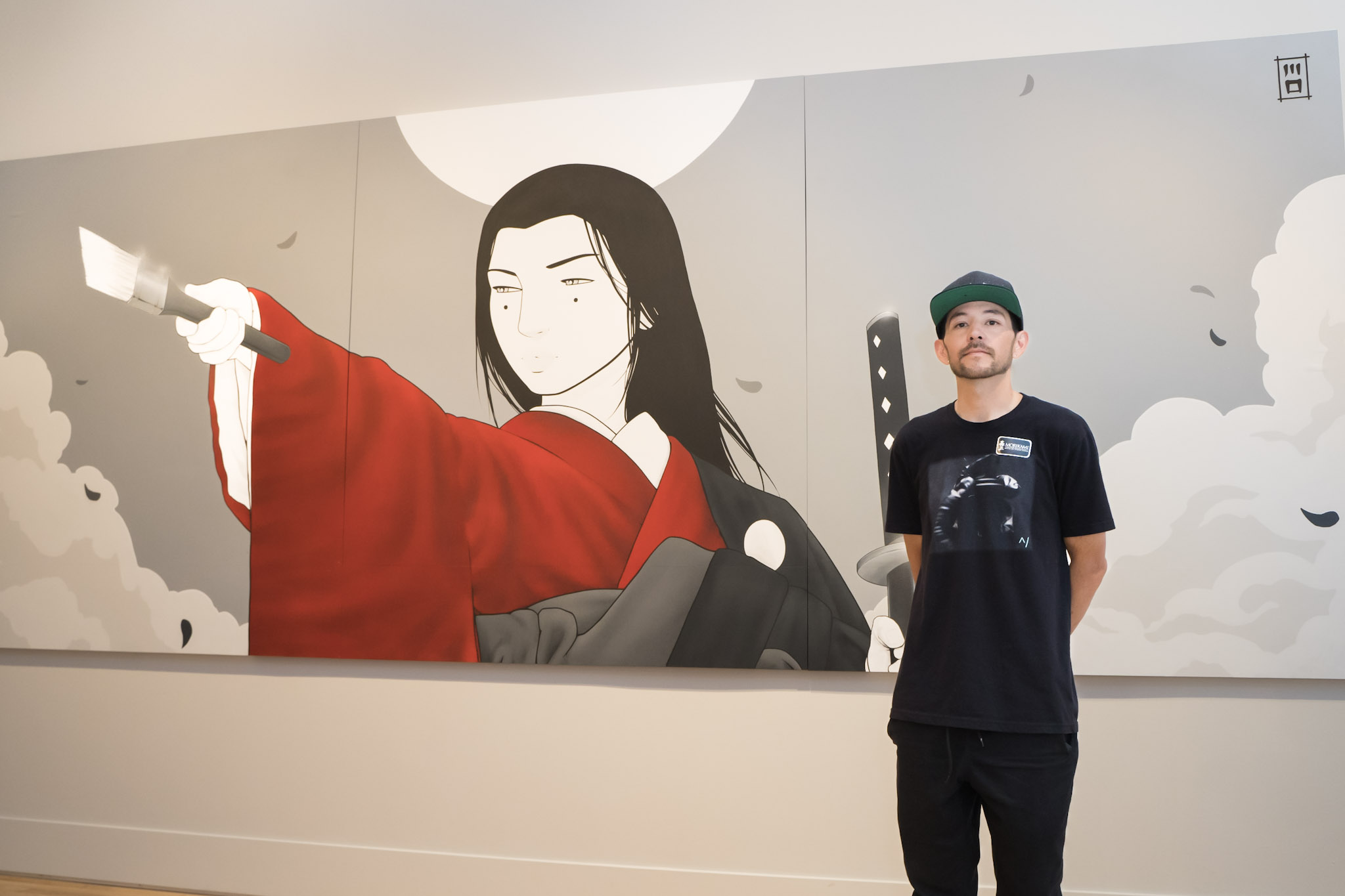 Casey Kawaguchi with his mural at Morikami Museum and Japanese Gardens