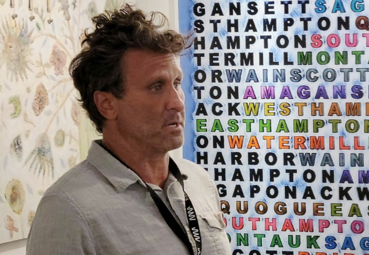 Bruce Reinfeld with his piece naming the hamlets and villages of the Hamptons for Southampton Art Festival