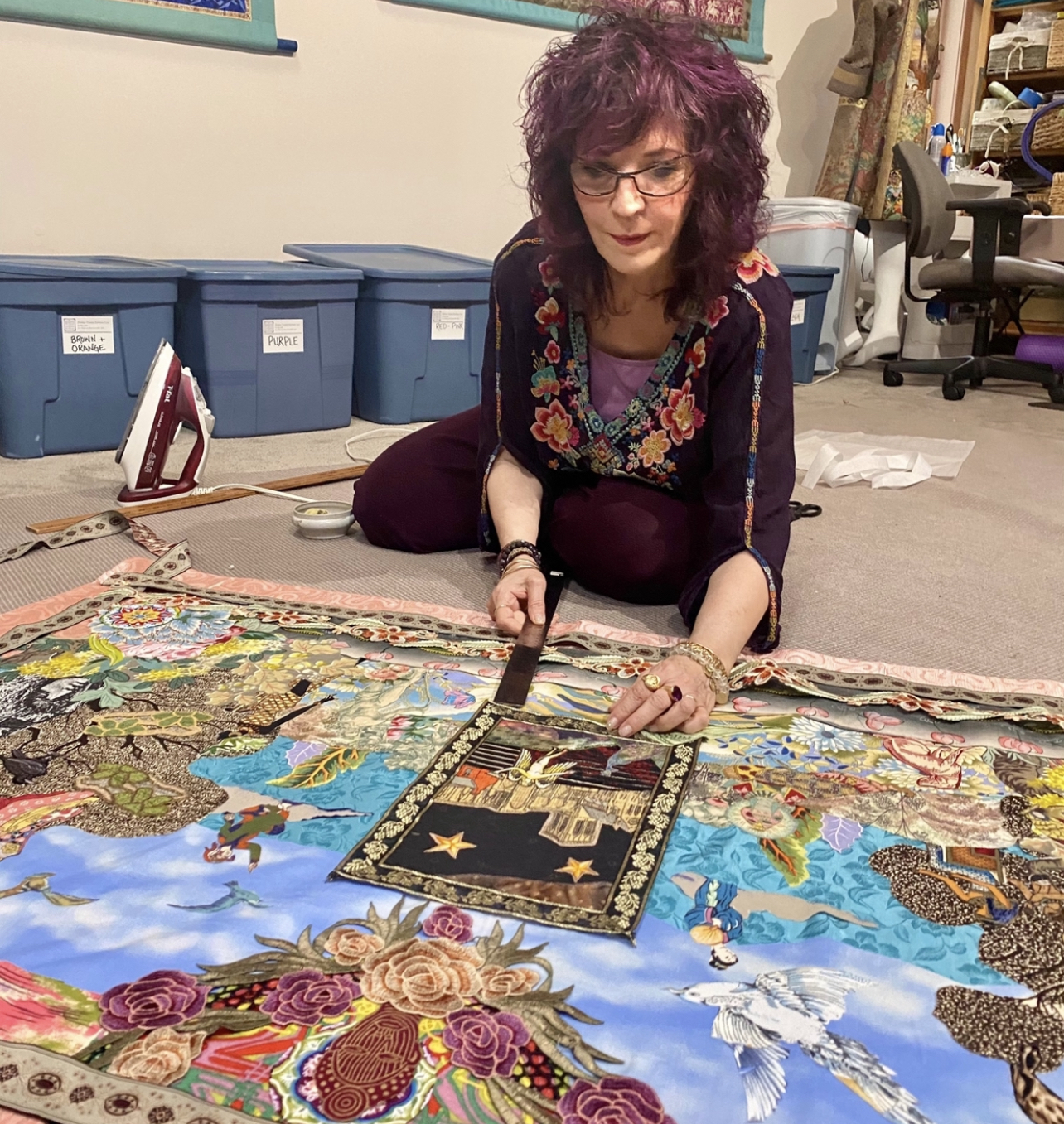 Amy Zerner working on a mixed-media collage tapestry