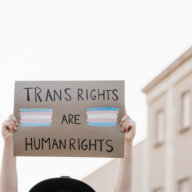 Transgender woman at gay pride protest holding transgender flag banner - Lgbt celebration event concept