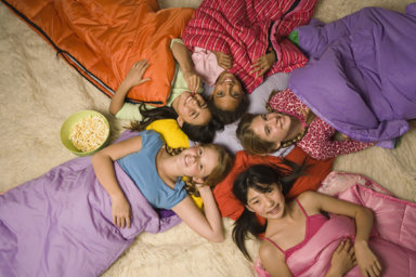 Group of preteen girls in sleeping bags