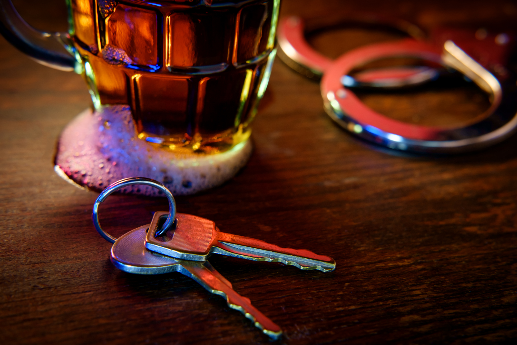 Mug of frothy beer with car keys - recipe for a DUI arrest