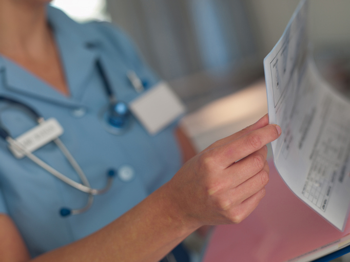 Nurse looking at patients medical chart