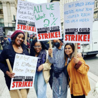 Writers strike Strikers with their picket signs