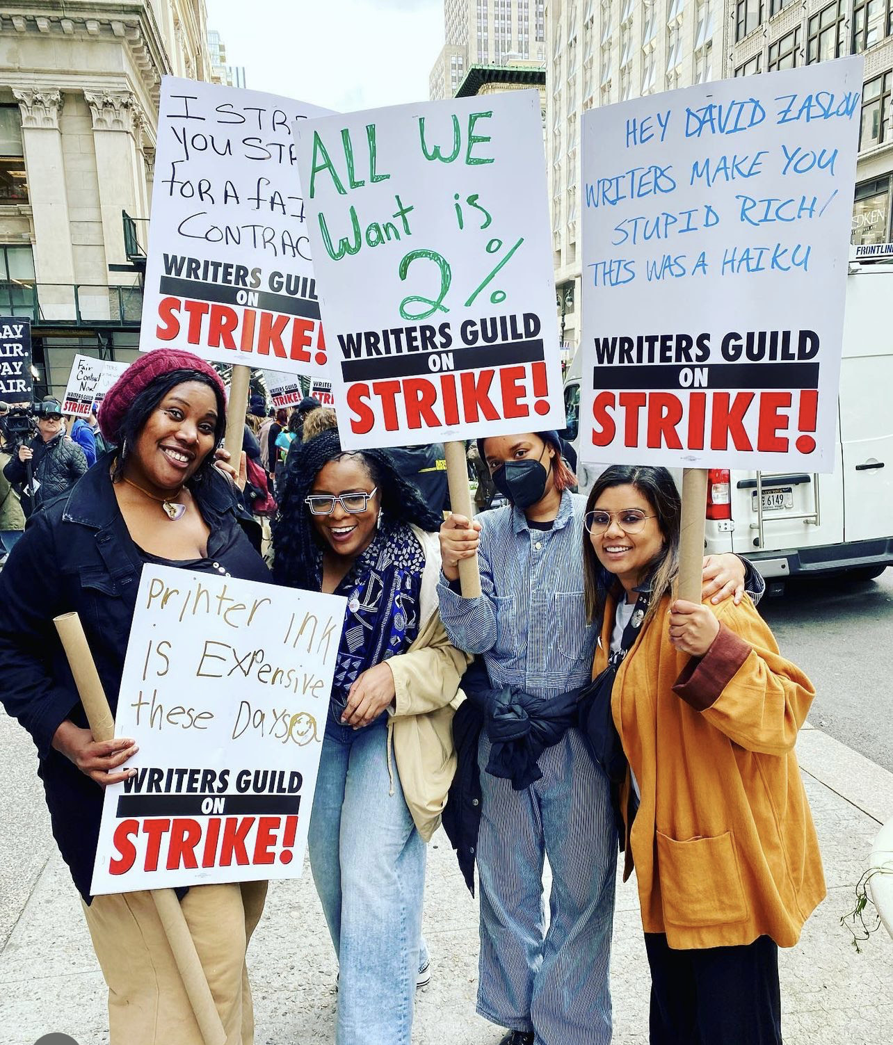 Writers strike Strikers with their picket signs