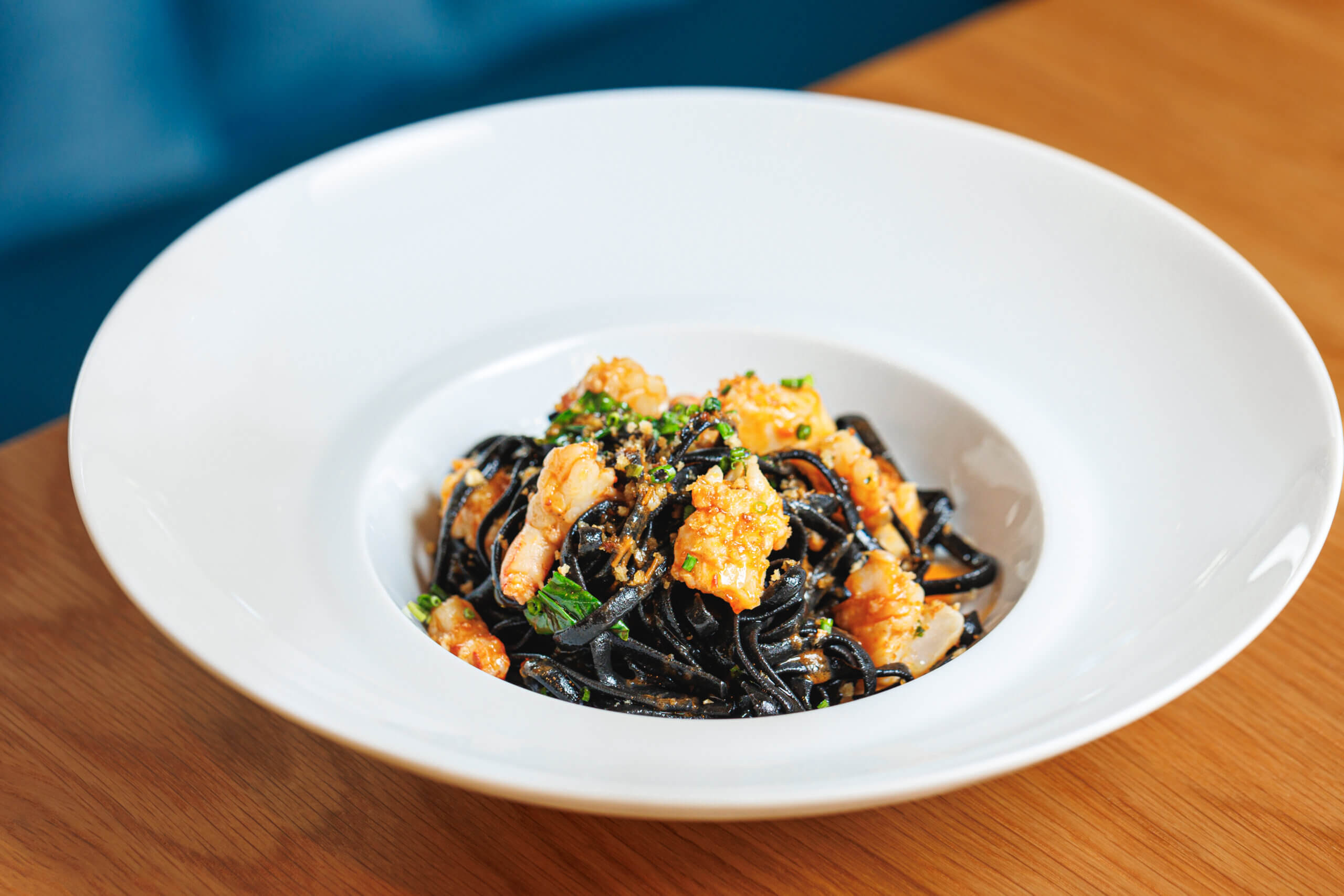 Squid ink linguine with mixed seafood, Calabrian chili paste, and bread crumbs
