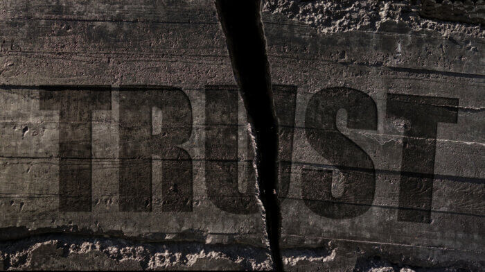 Trust text etched in cracked textured stone background