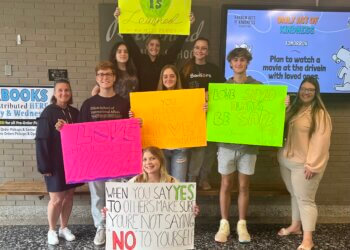 Members of Riverhead High School's Healthy YOUniversity with posters from their positivity campaign