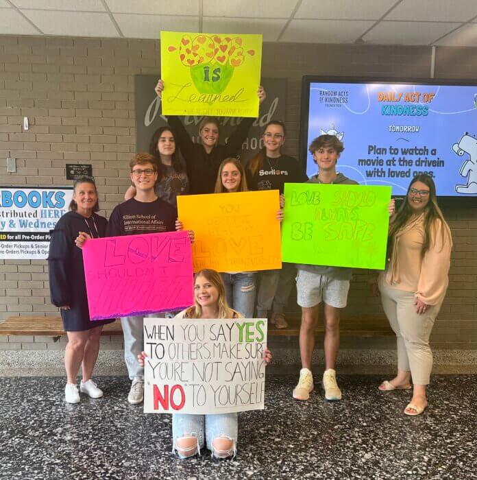 Members of Riverhead High School's Healthy YOUniversity with posters from their positivity campaign