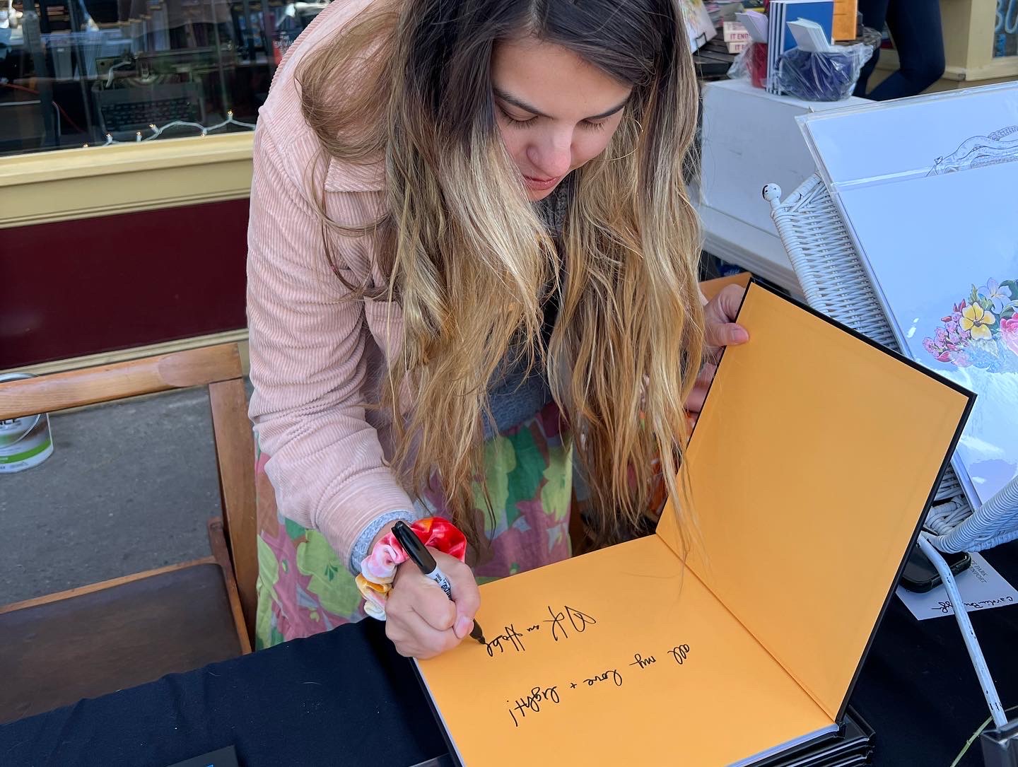 Kara Hoblin signs a copy of her book "The East End A to Z"