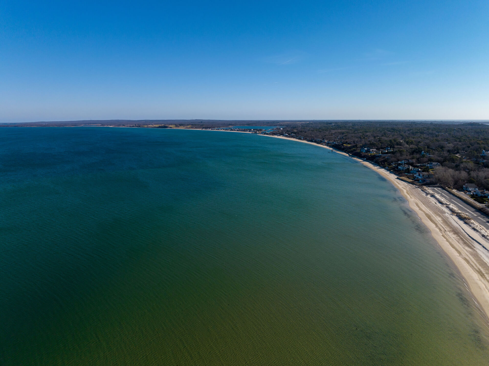 An aerial of the sandy Meschutt Beach and the Great Peconic Bay on Long Island on a sunny day - great for seaweed growth