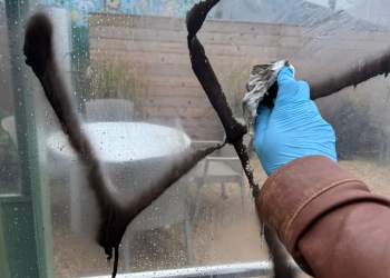 Cleaning the hateful anti-Semitic swastika Nazi graffiti in Montauk
