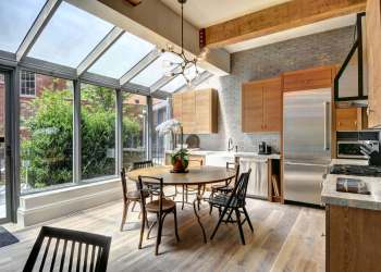 The glassed-in kitchen solarium also serves as the entrance to this condo unit. Courtesy of the CeeJack Team
