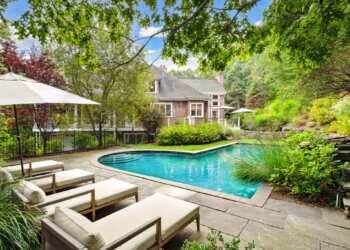 Lush landscaping surrounds the heated pool at the home at 1620 Deerfield Road in Water Mill, Courtesy of Mala Sander