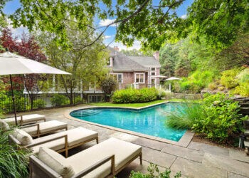 Lush landscaping surrounds the heated pool at the home at 1620 Deerfield Road in Water Mill, Courtesy of Mala Sander