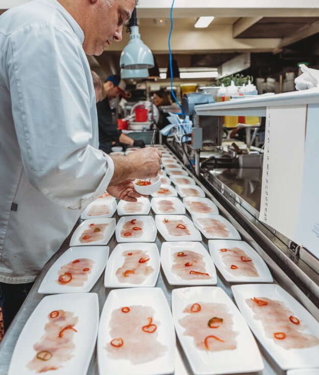 A chef from Nick & Toni's preparing the Feast of the Seven Fishes