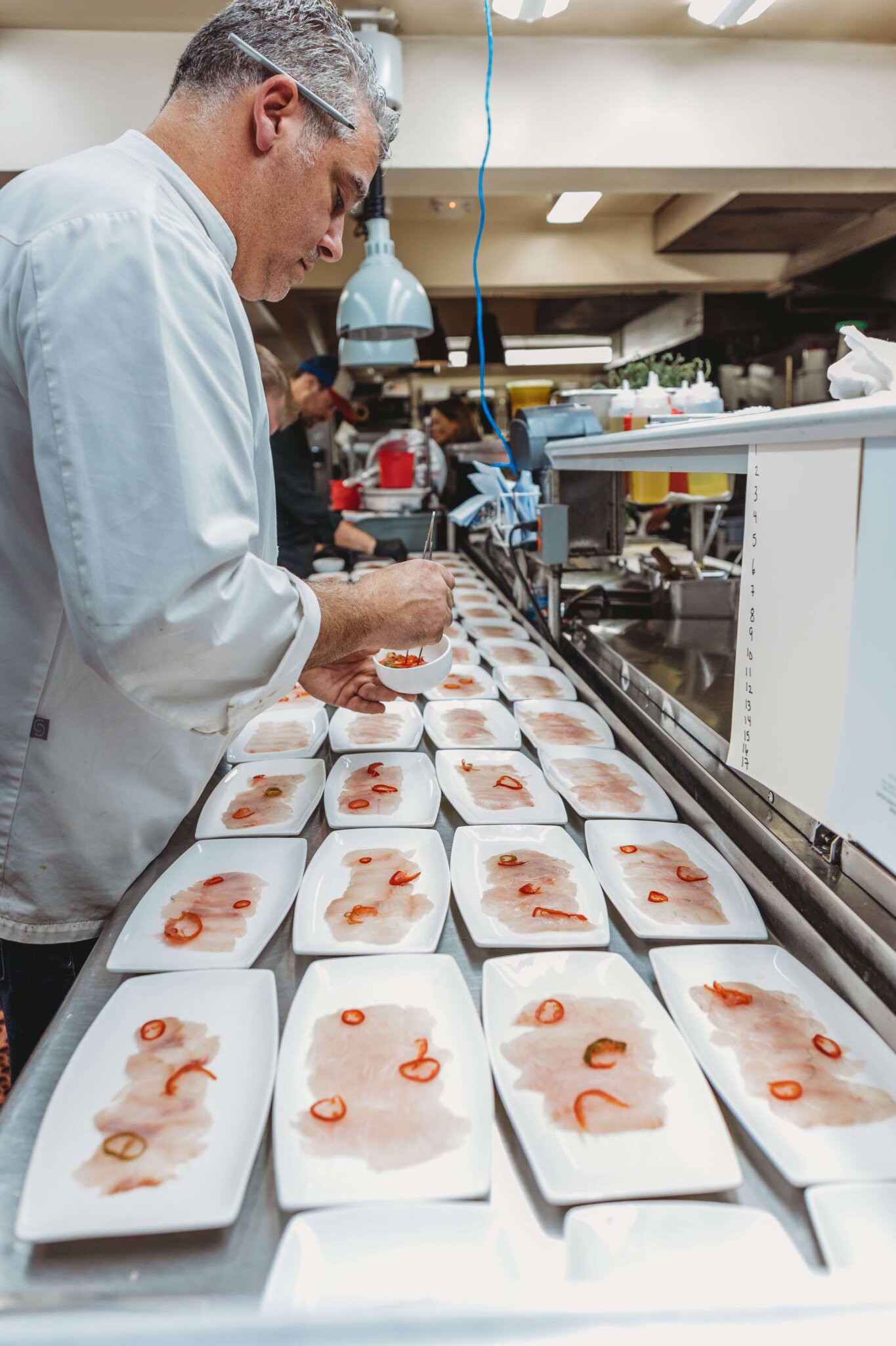 A chef from Nick & Toni's preparing the Feast of the Seven Fishes